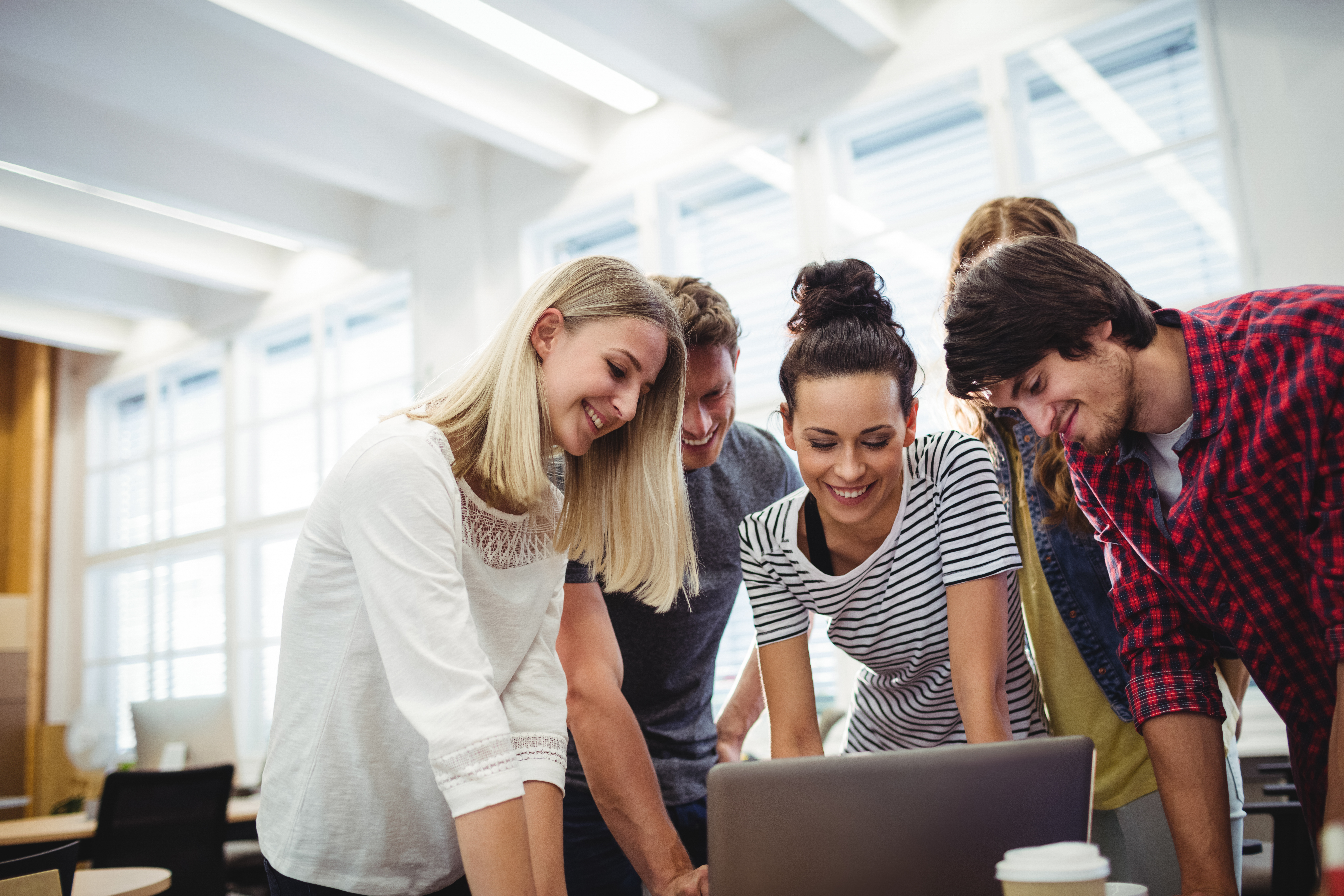 Group of business executives using laptop at their desk Group of business executives using laptop at their desk